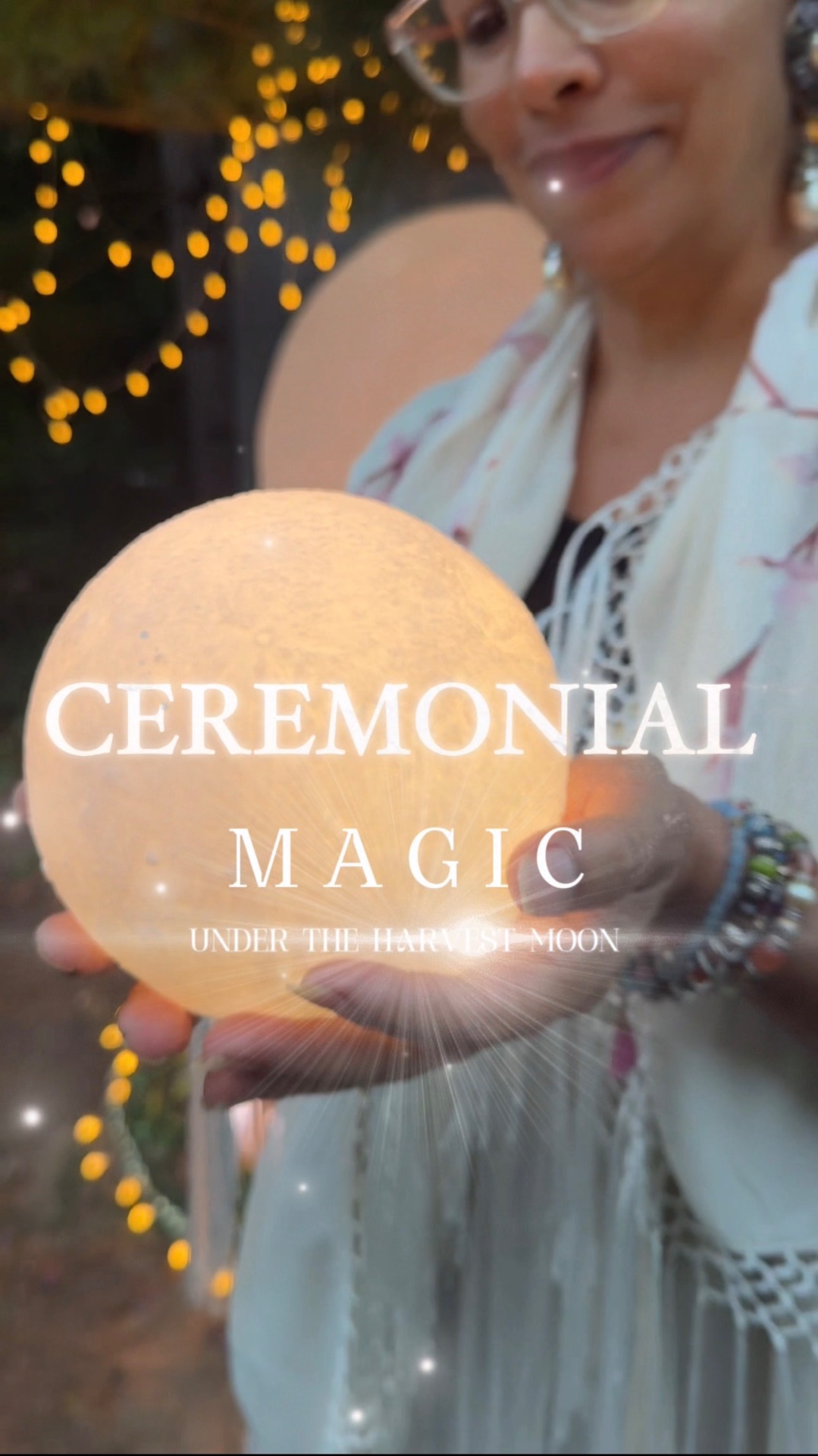 Mariela holding a glowing moon titled Ceremonial Magic under the Harvest Moon