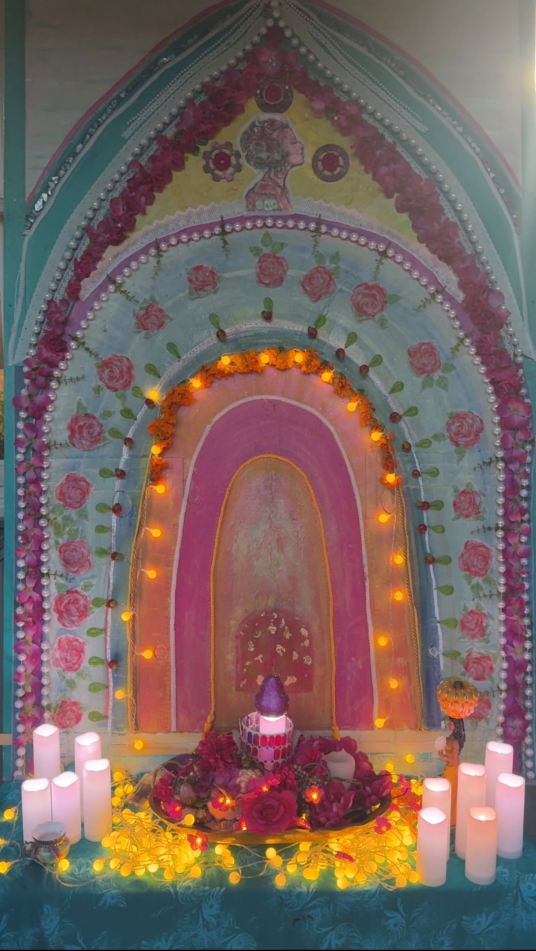 The entrance to the Divine Mother altar, adorned with roses, pearls, and candlelight
