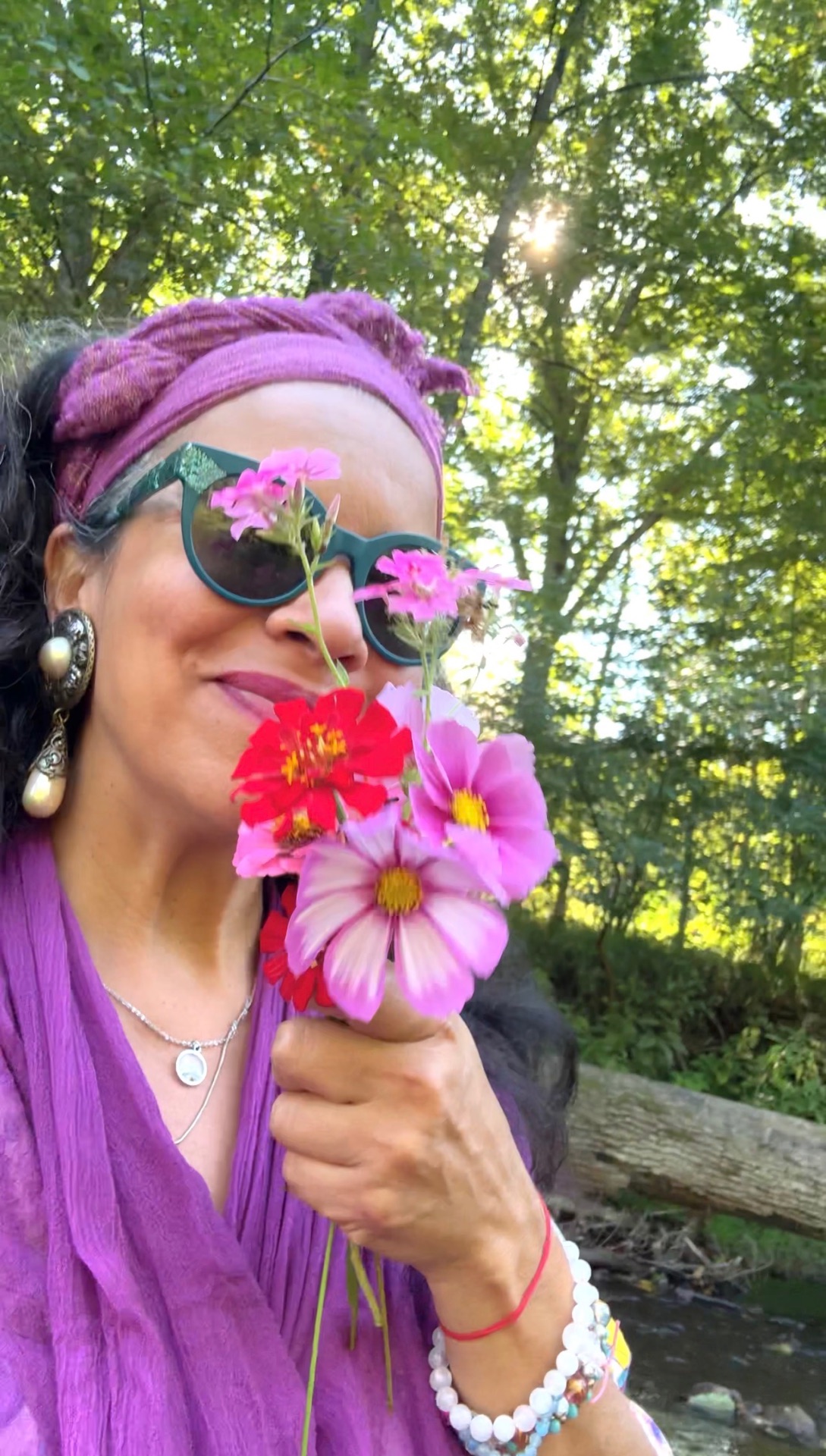 Reverent Mariela smiling with a bouquet of wildflowers